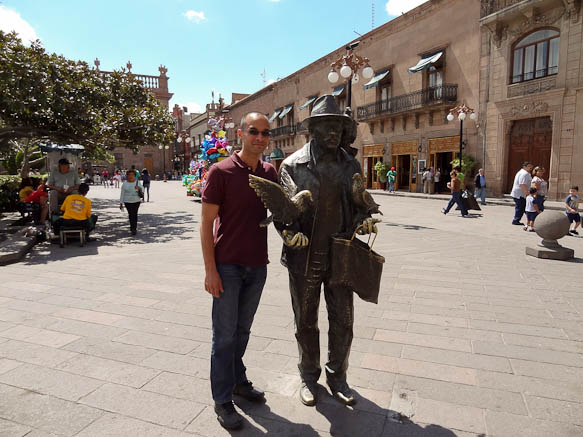 Me with a statue in a plaza in San Luis Potosi