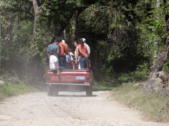 A Pickup Truck Taking People Up The Mountain
