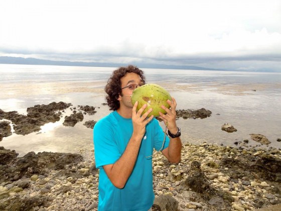 drinking out of a coconut