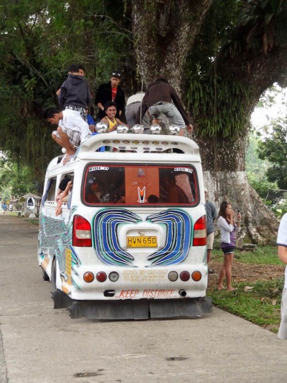 people riding on the roof of a bus