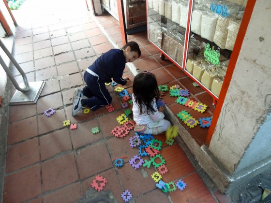 Happy Kids Playing In The Ciudad Bolivar Market