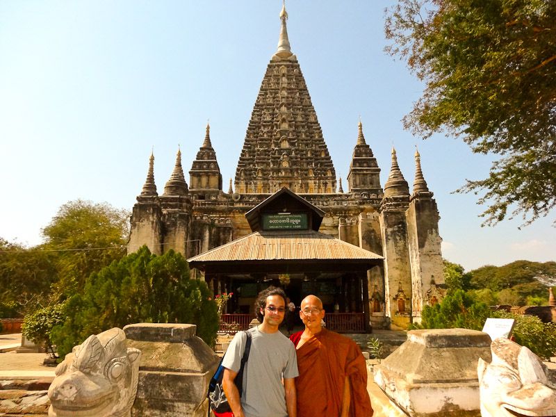 At A Temple Entrance With A Monk